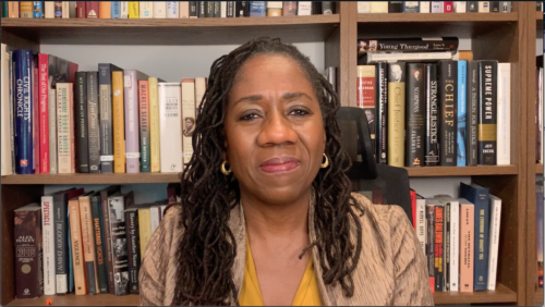Sherrilyn Ifill smiling sitting in front of a bookcase