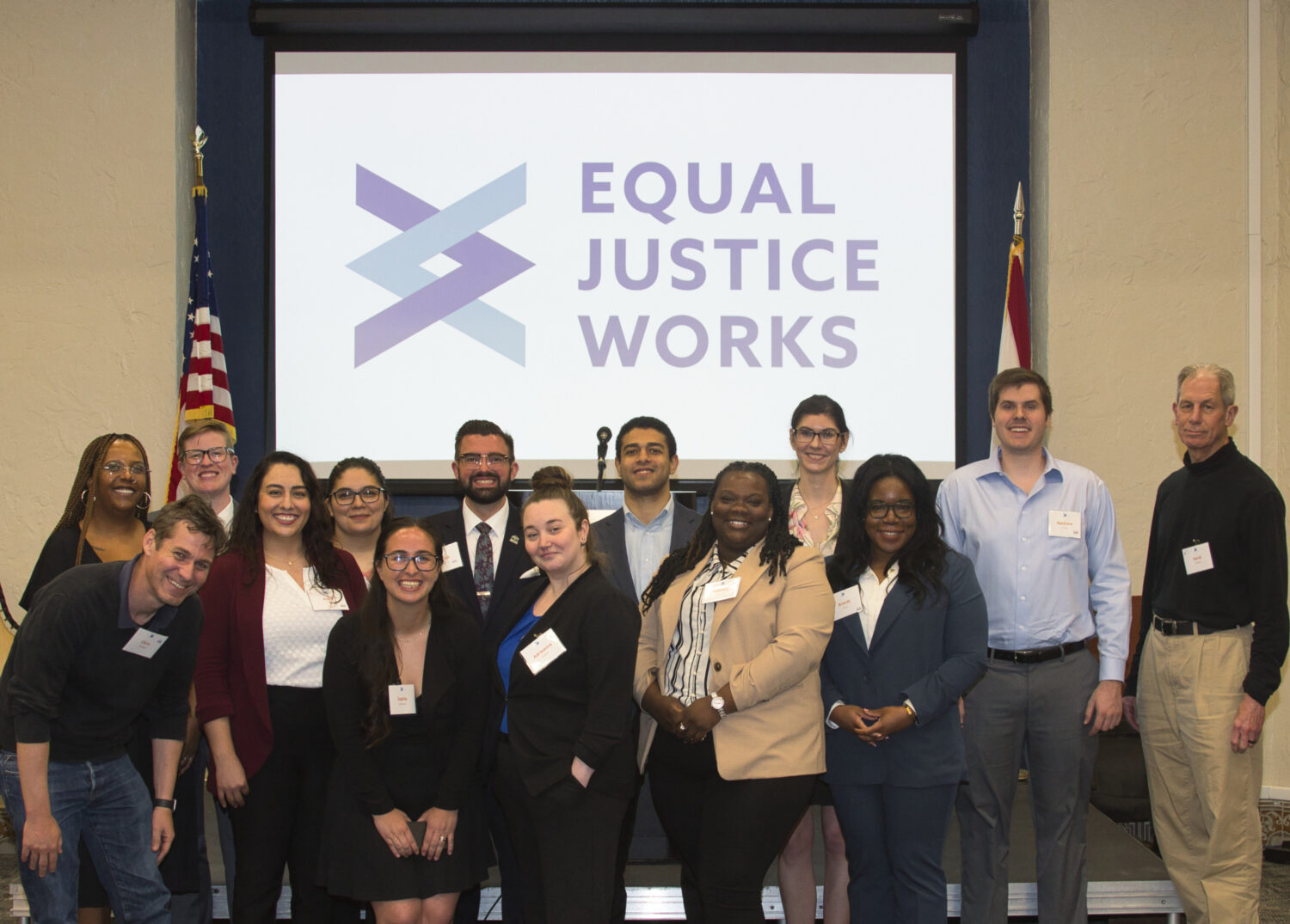 A group of Fellow attendees stands in front of the stage at the 2023 Disaster Resilience Symposium